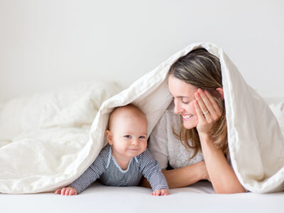 Mother And Her Little Baby Boy, Playing Together In Bedrroom, Happy Family Concept